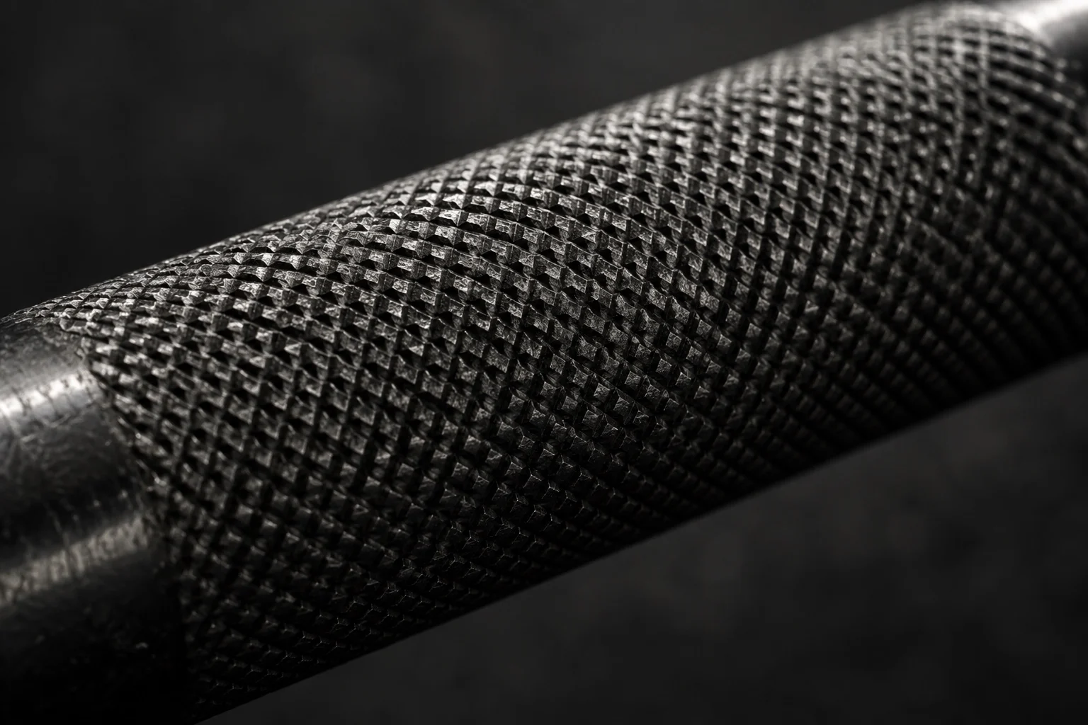 Extreme close-up of diamond knurling on a steel handle